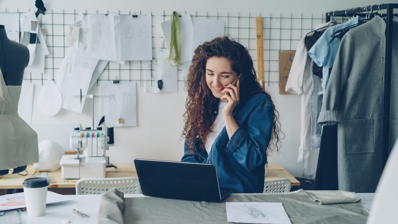 Person on a phone call while working at a laptop